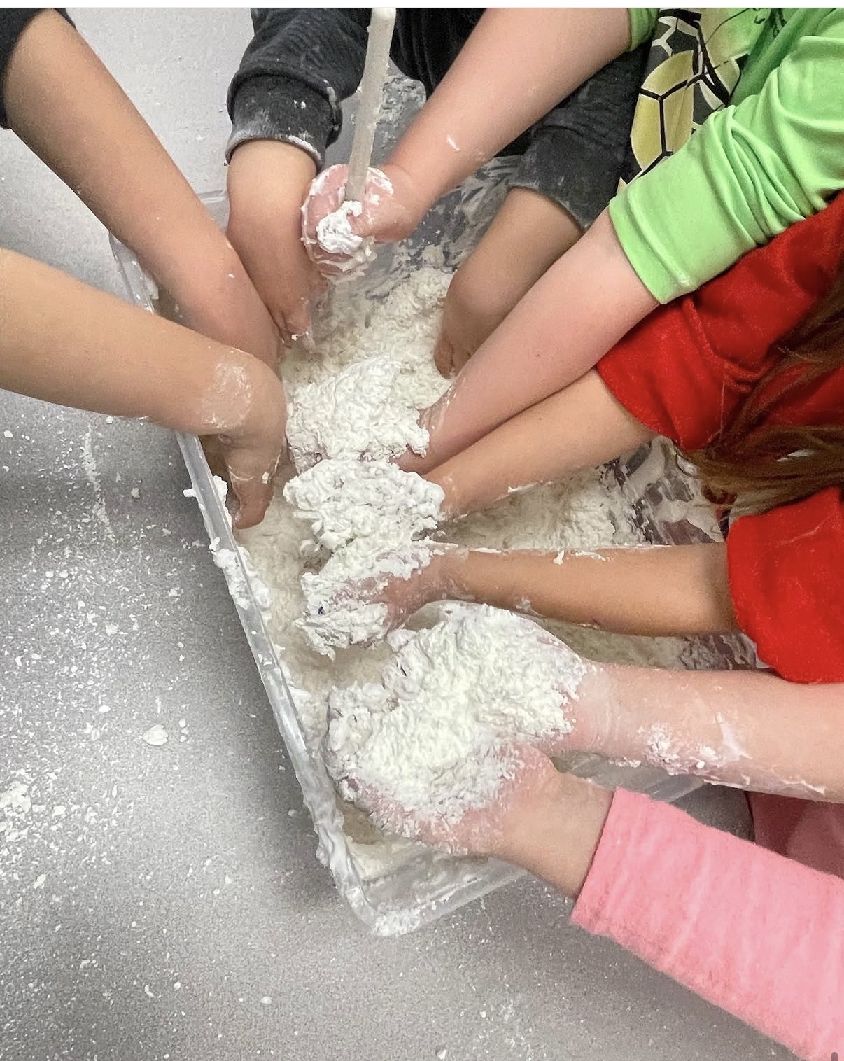 Children enjoying colorful messy play activities in a bright classroom